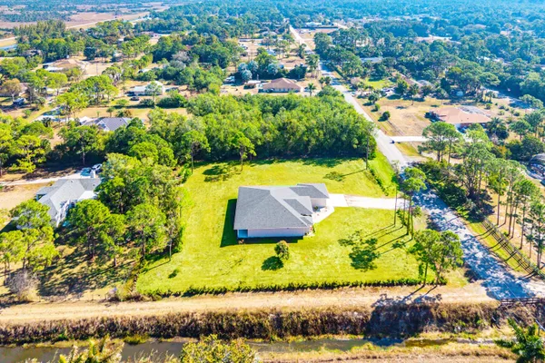 an aerial view of residential houses with yard