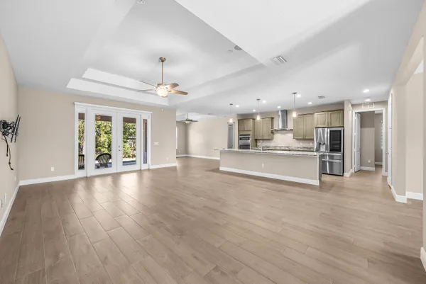 a view of large kitchen with wooden floor and a kitchen
