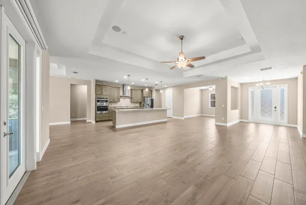 a view of a kitchen with a sink and a refrigerator