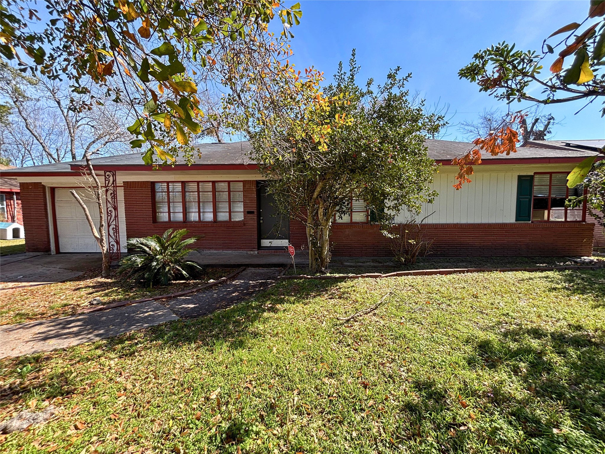 a view of house with backyard and sitting area
