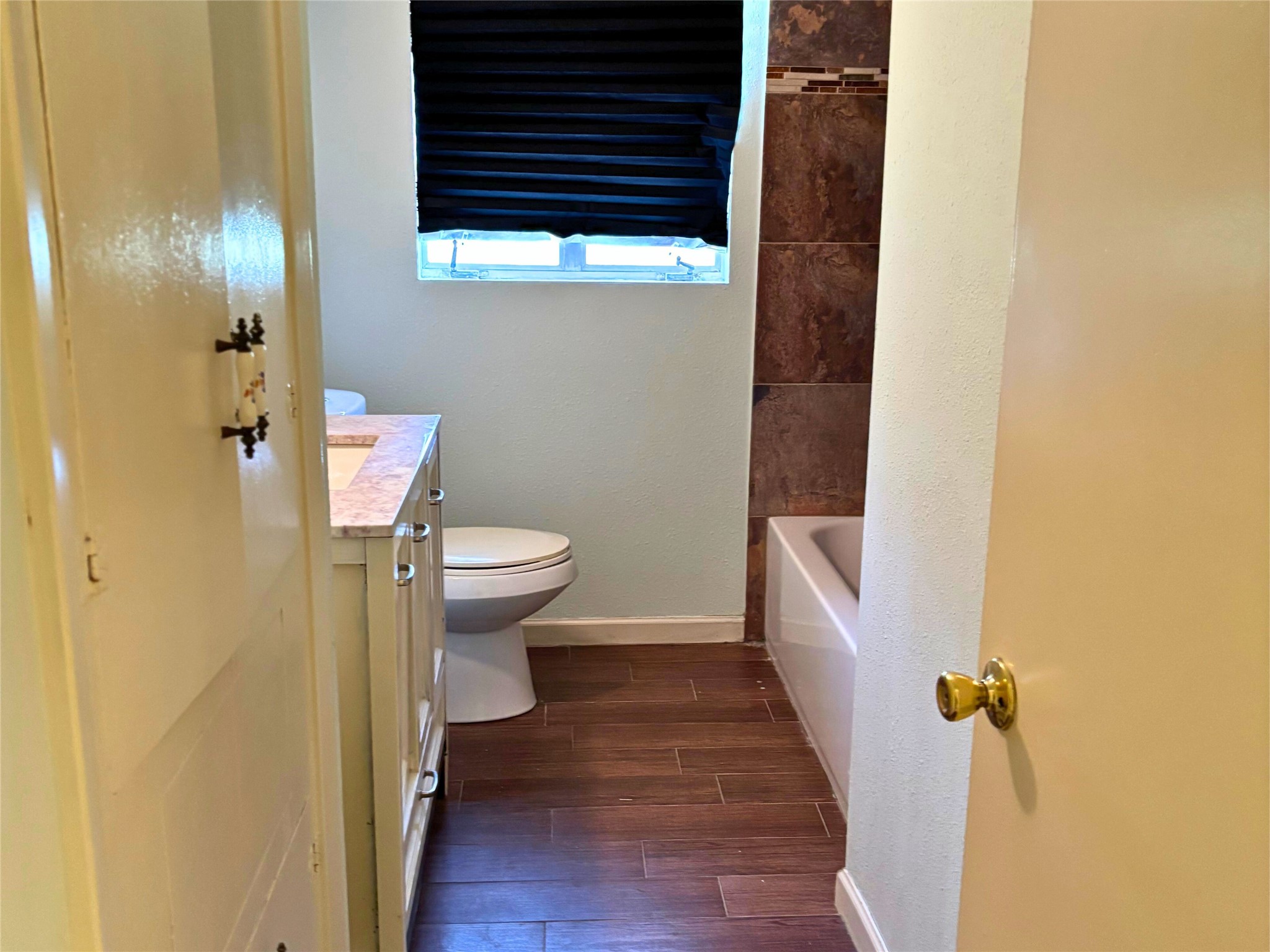 7022 Merriwood Lane Houston, TX 77076 - Photo 11 of 12 a bathroom with a sink and toilet
