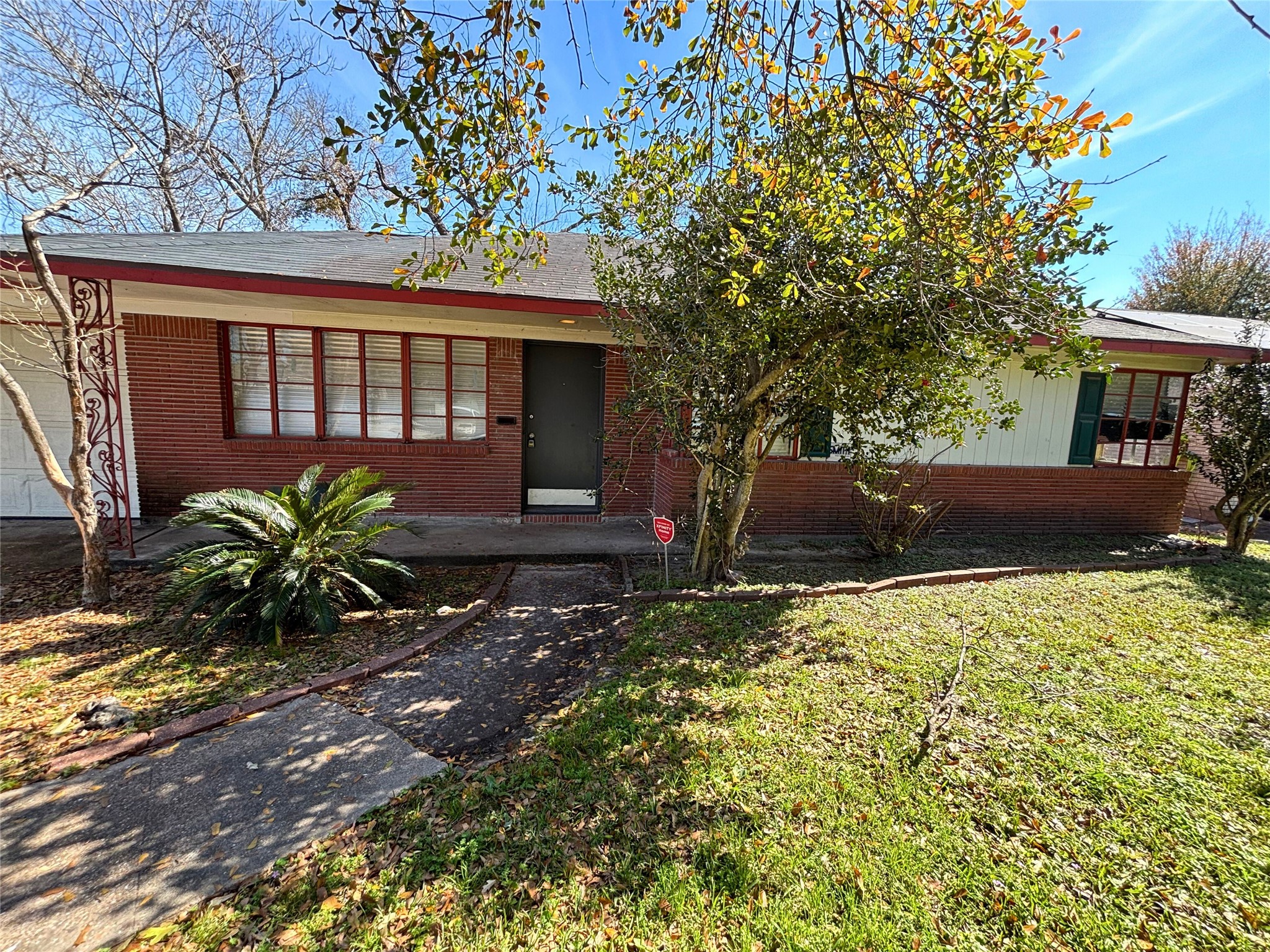 7022 Merriwood Lane Houston, TX 77076 - Photo 12 of 12 a front view of a house with garden
