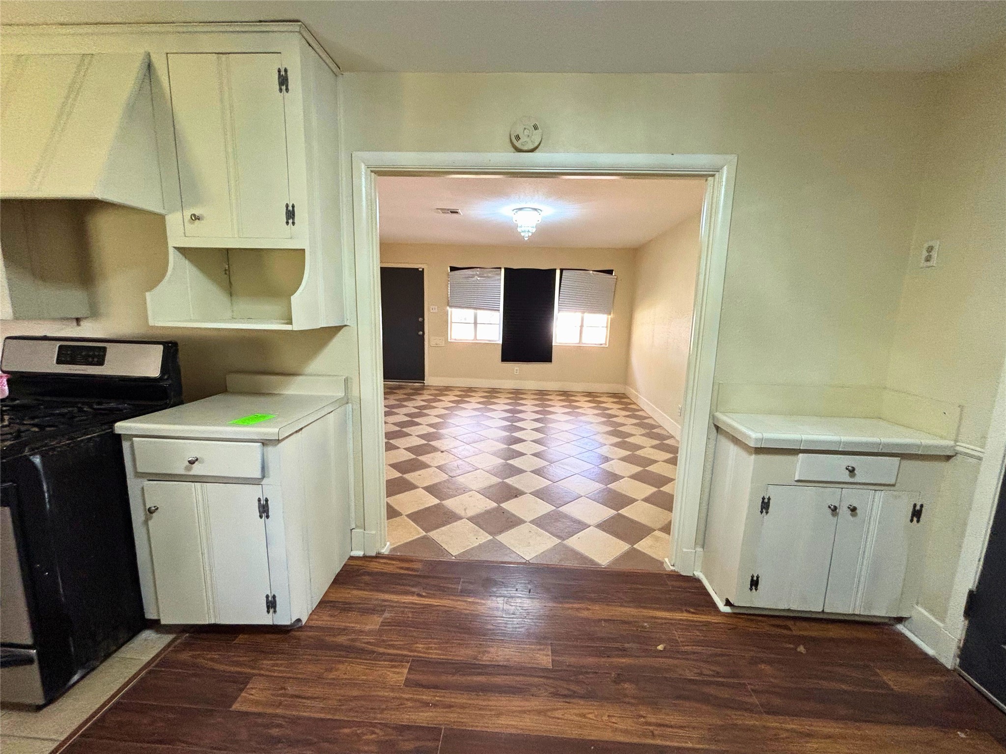 7022 Merriwood Lane Houston, TX 77076 - Photo 5 of 12 a view of a hallway with wooden floor and cabinets