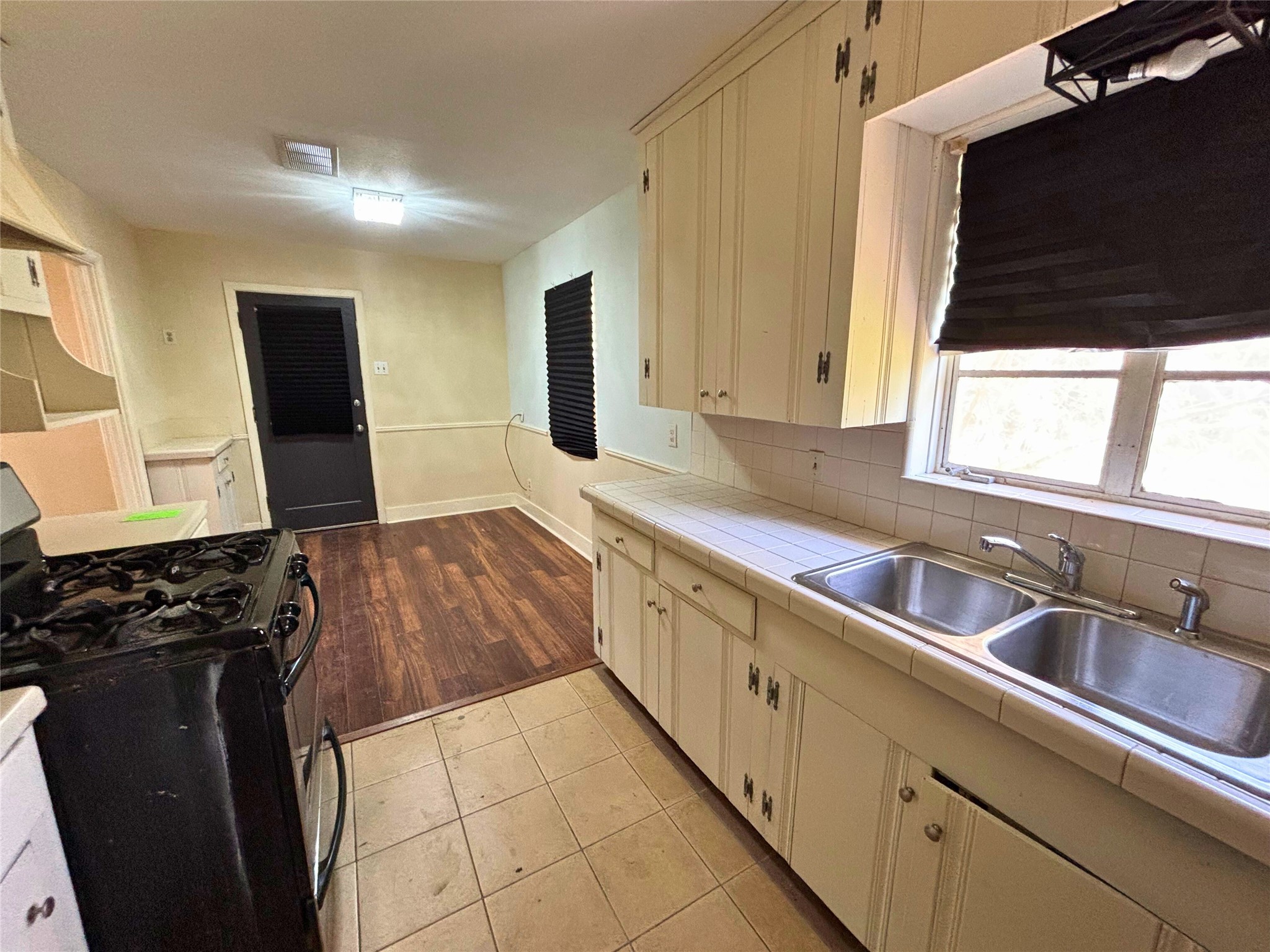 7022 Merriwood Lane Houston, TX 77076 - Photo 6 of 12 a kitchen with granite countertop a sink and a stove top oven