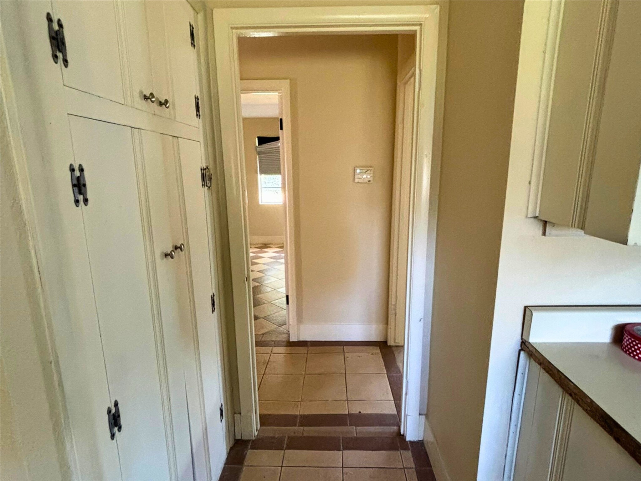7022 Merriwood Lane Houston, TX 77076 - Photo 7 of 12 a view of a hallway with wooden floor and closet area