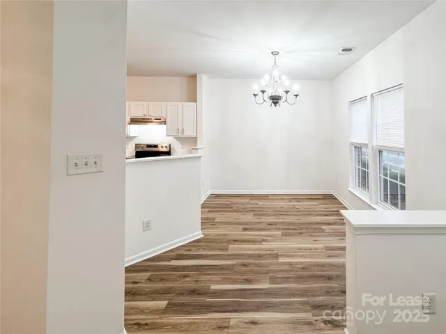 a view of kitchen with cabinets and wooden floor