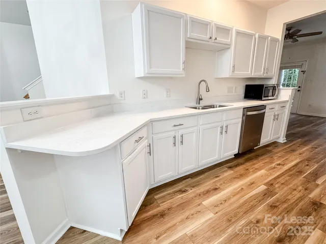 a kitchen with a sink a stove a refrigerator and a microwave