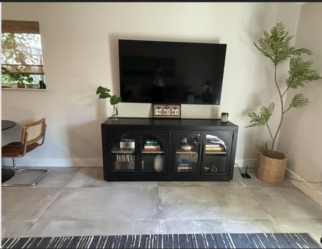 1822 Windsor Drive, Unit 1 Juno Ridge, FL 33408 - Photo 2 of 12 a living room with a fireplace and a flat screen tv