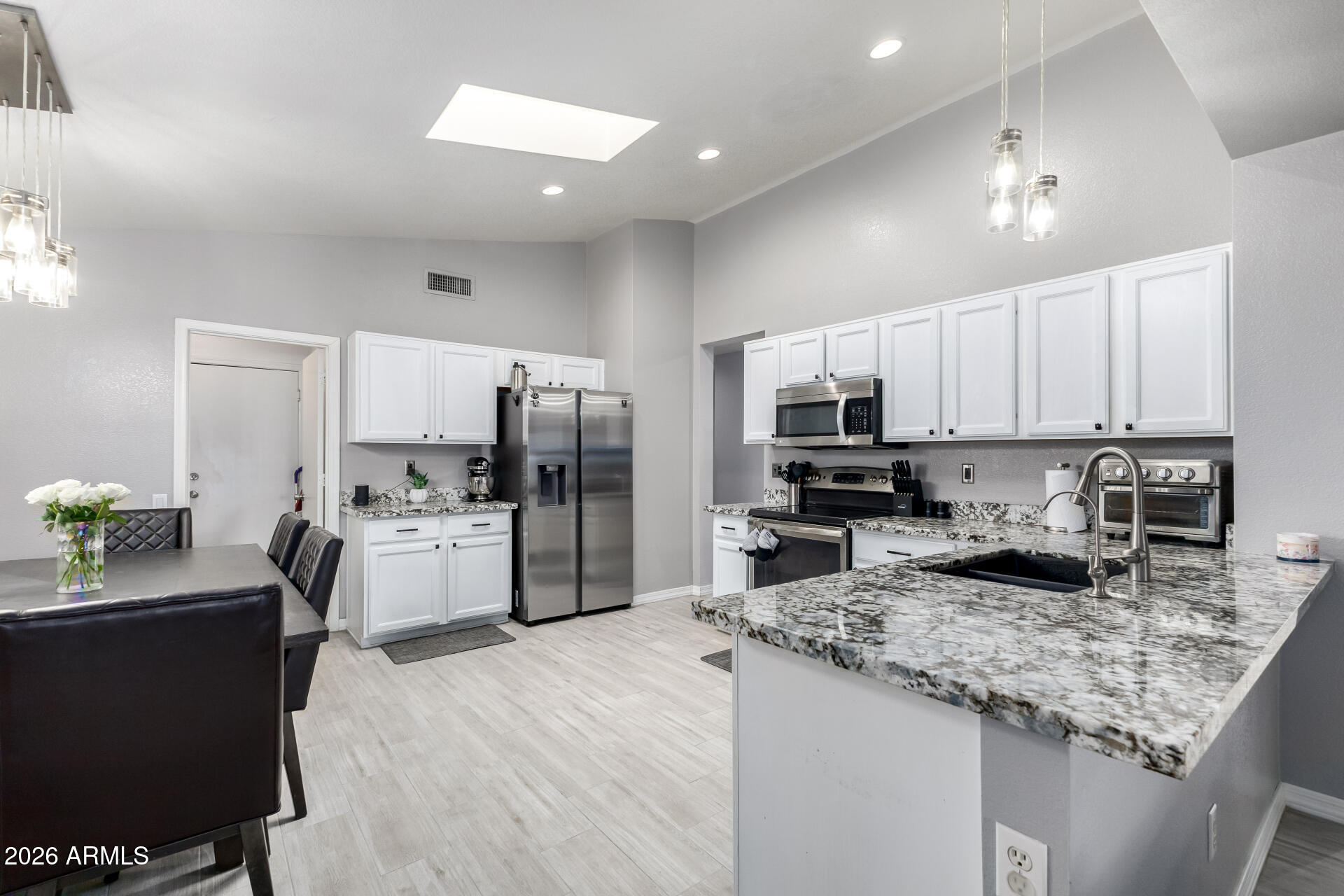 3407 East Escuda Road Phoenix, AZ 85050 - Photo 11 of 32 a kitchen with refrigerator and cabinets