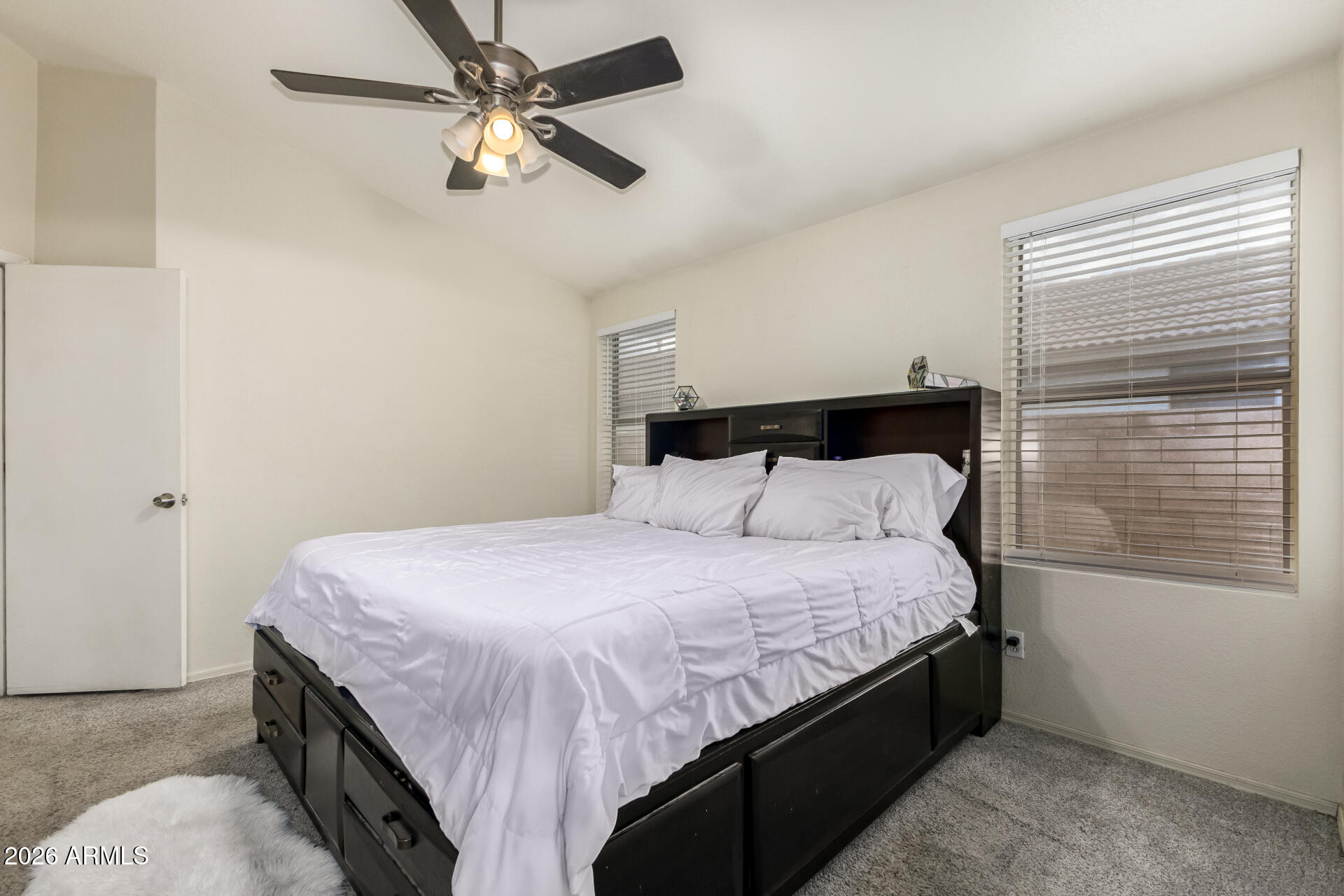 3407 East Escuda Road Phoenix, AZ 85050 - Photo 14 of 32 a bedroom with a bed and a chandelier