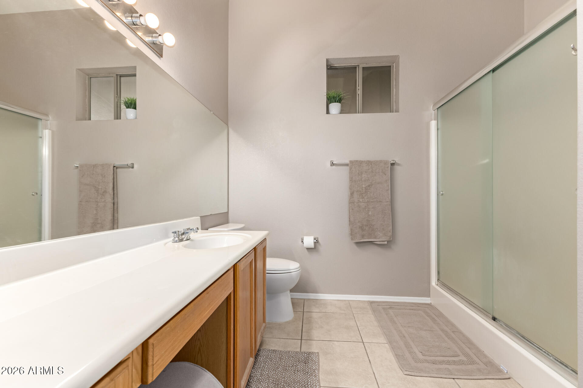 3407 East Escuda Road Phoenix, AZ 85050 - Photo 16 of 32 a bathroom with a sink a toilet and mirror