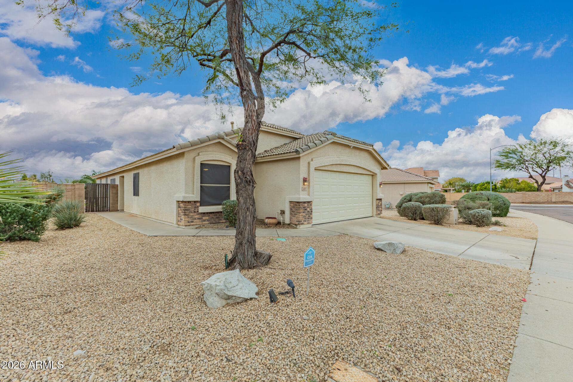 3407 East Escuda Road Phoenix, AZ 85050 - Photo 2 of 32 a front view of a house with garden