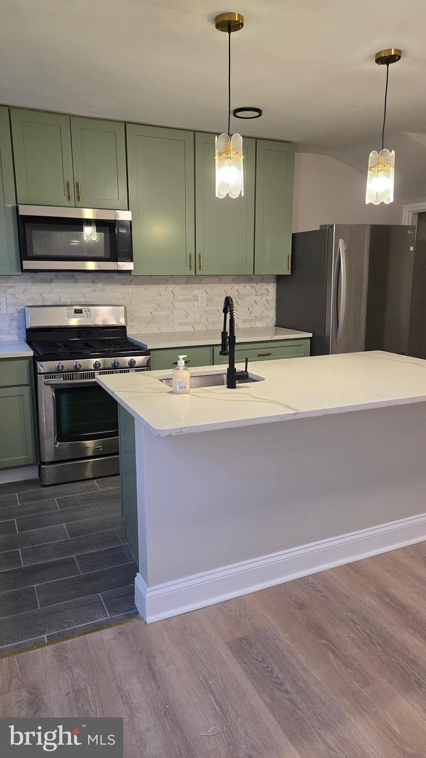 614 Cheraton Road Baltimore, MD 21225 - Photo 4 of 26 a kitchen with a stove and a microwave