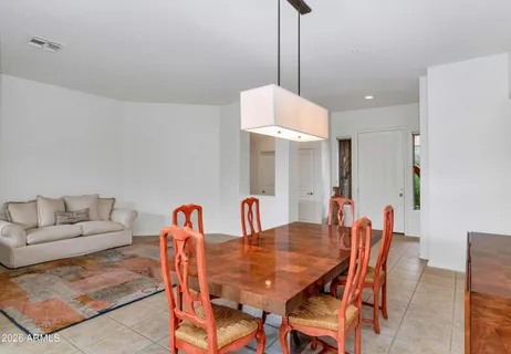 a dining room with furniture a table and chairs