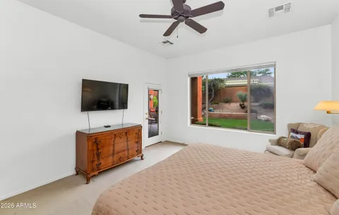a bedroom with a bed and a flat screen tv