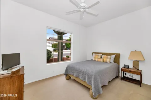 a bedroom with a bed and a window