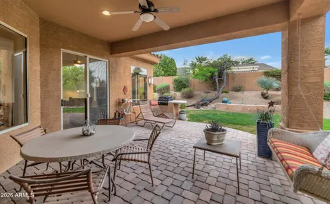 a view of a patio with a dining table and chairs with wooden floor