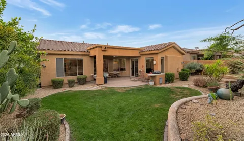 a view of a house with a backyard porch and sitting area
