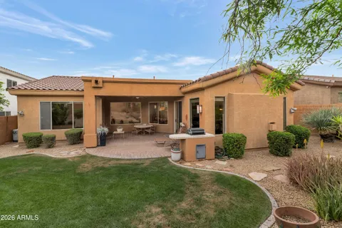 a view of a house with backyard porch and sitting area