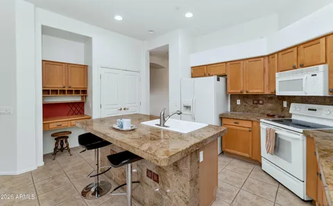 a kitchen with a sink stove and white cabinets