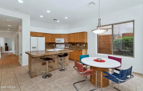 a kitchen with a dining table and chairs