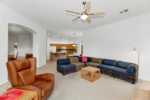 a living room with furniture and a ceiling fan