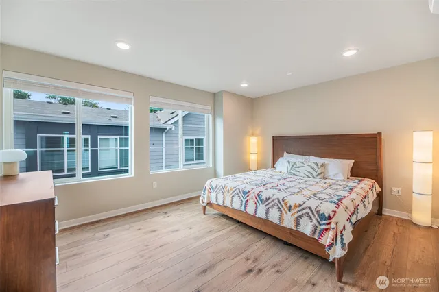 a bedroom with a large bed and a large window