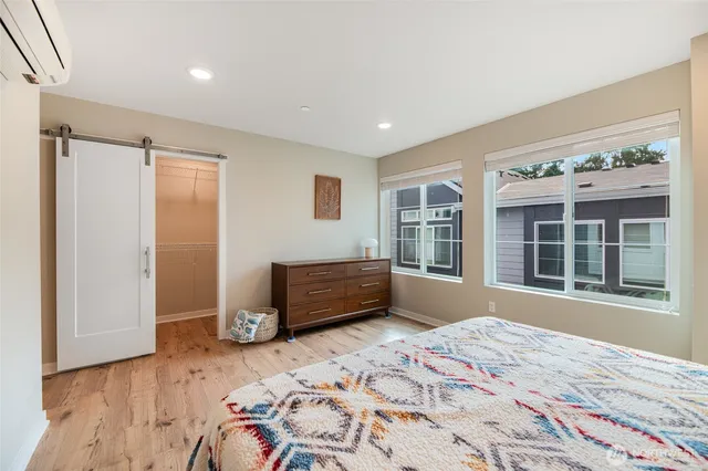 a bedroom with a bed and wooden floor