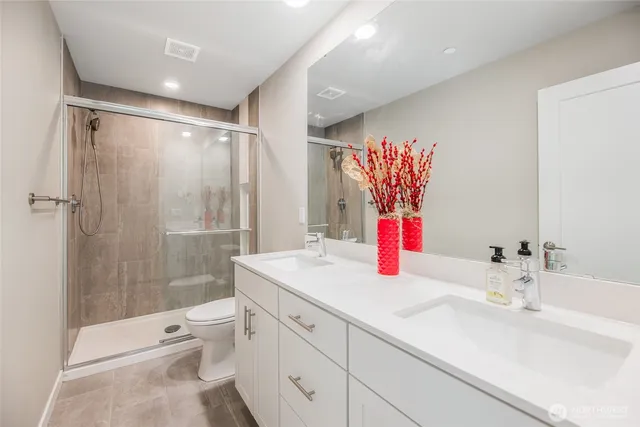 a bathroom with a sink vanity mirror and toilet