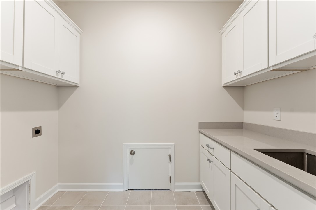 405 Botany Lane Anderson, SC 29621 - Photo 22 of 30 This functional laundry area features ample cabinetry and practical counter space for everyday tasks.