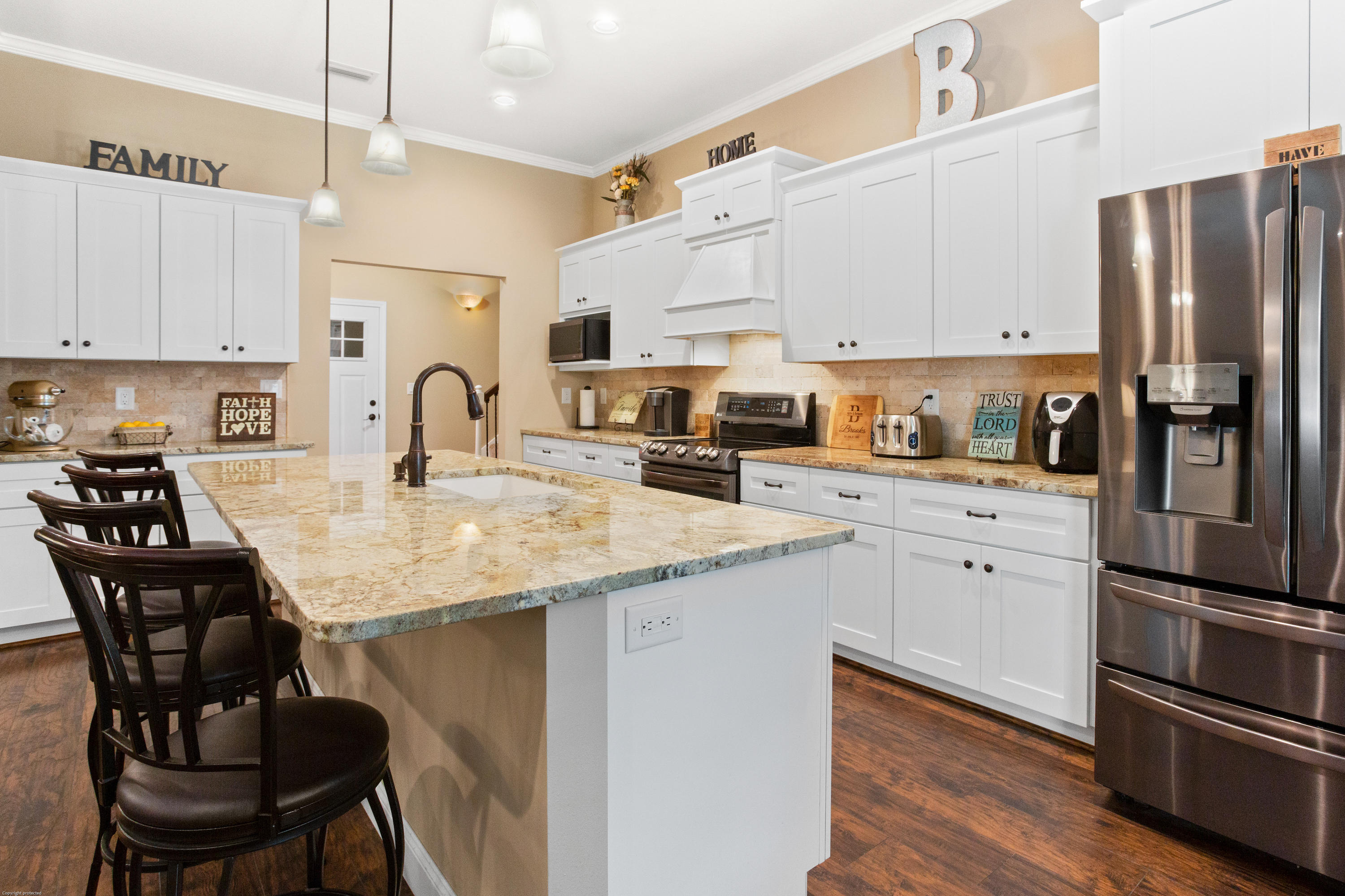 5887 Oak Hill Road Crestview, FL 32536 - Photo 8 of 44 a kitchen with stainless steel appliances granite countertop a sink a stove a refrigerator cabinets and chairs