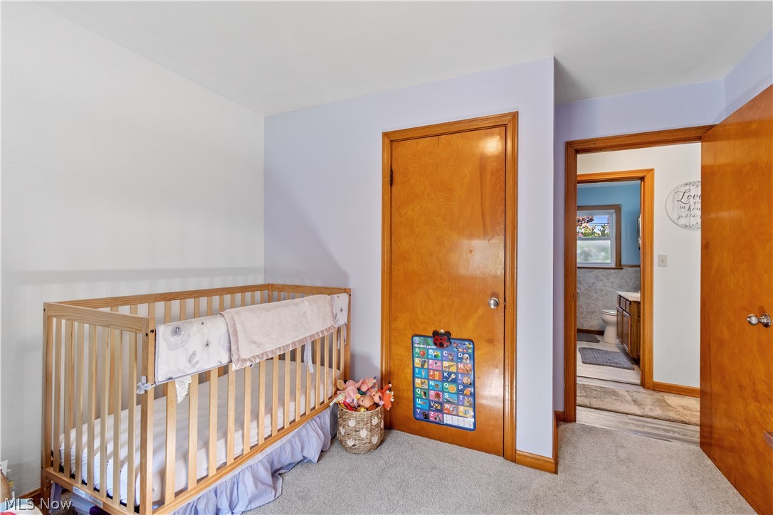 1724 Spring Valley Avenue Northwest Canton, OH 44708 - Photo 15 of 30 Bedroom featuring light colored carpet and a nursery area