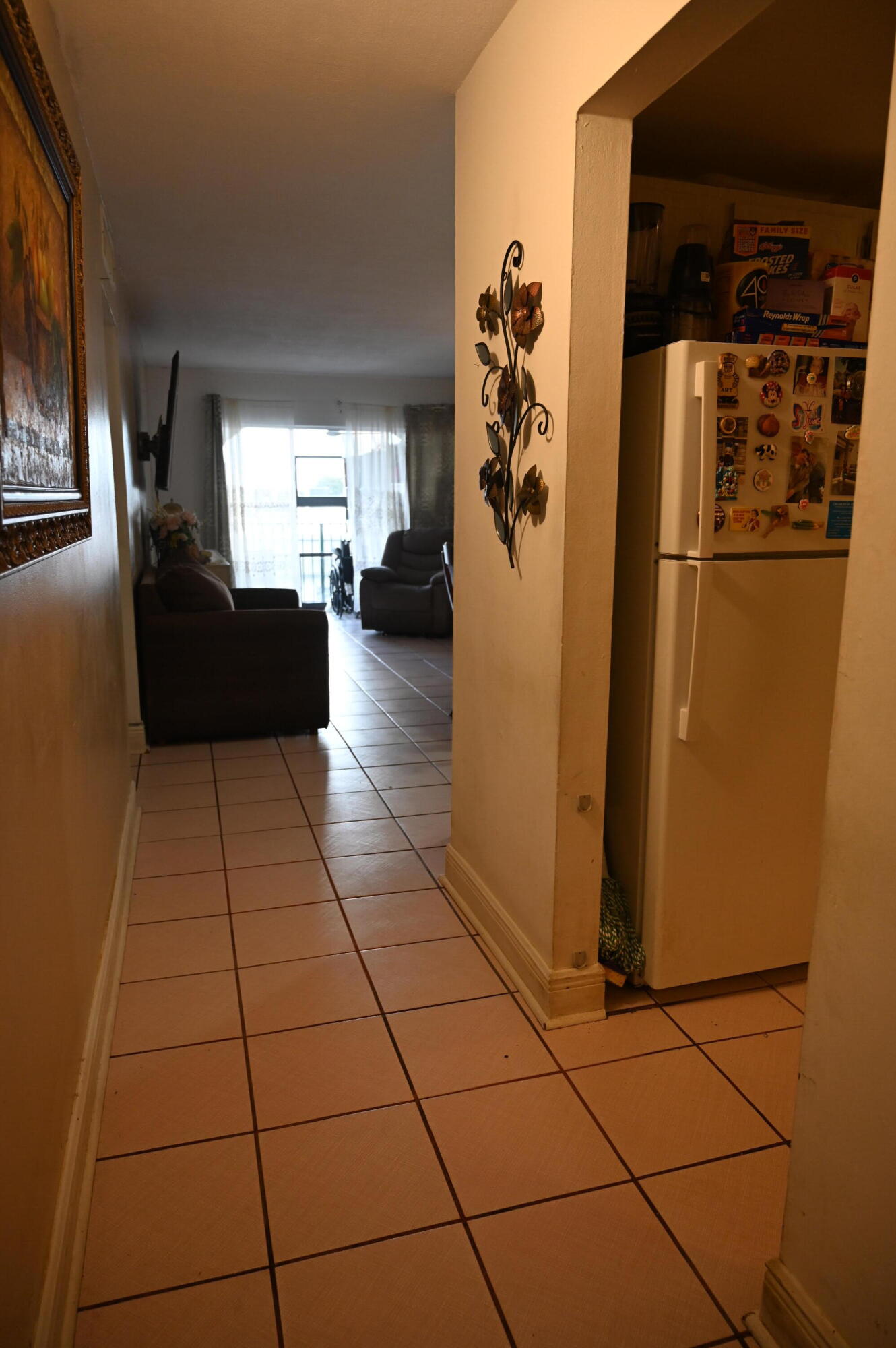 6215 West 20th Avenue, Unit 415 Hialeah, FL 33012 - Photo 12 of 39 a living room with a black white checkered floor