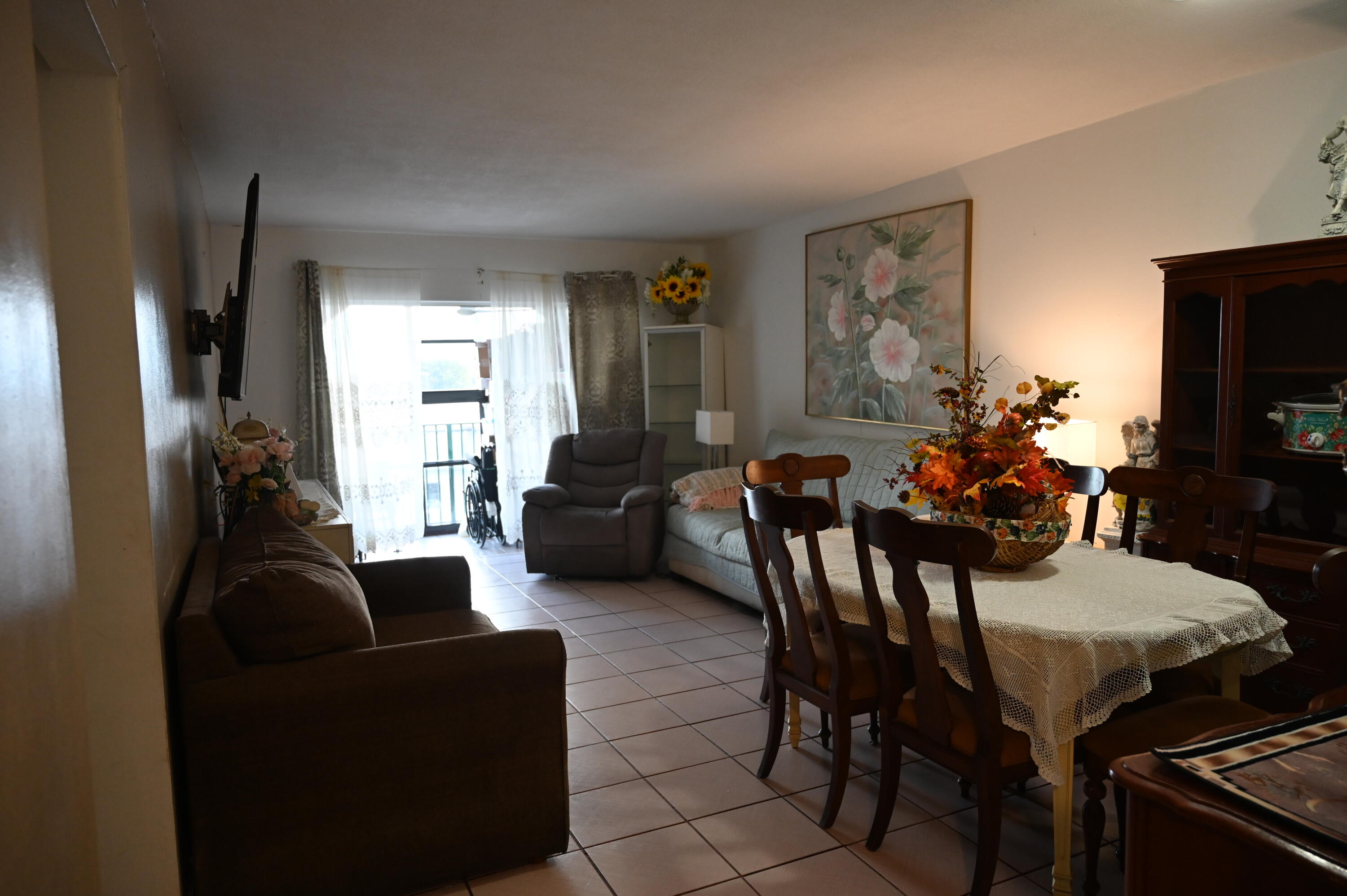 6215 West 20th Avenue, Unit 415 Hialeah, FL 33012 - Photo 13 of 39 a living room with furniture and a flat screen tv