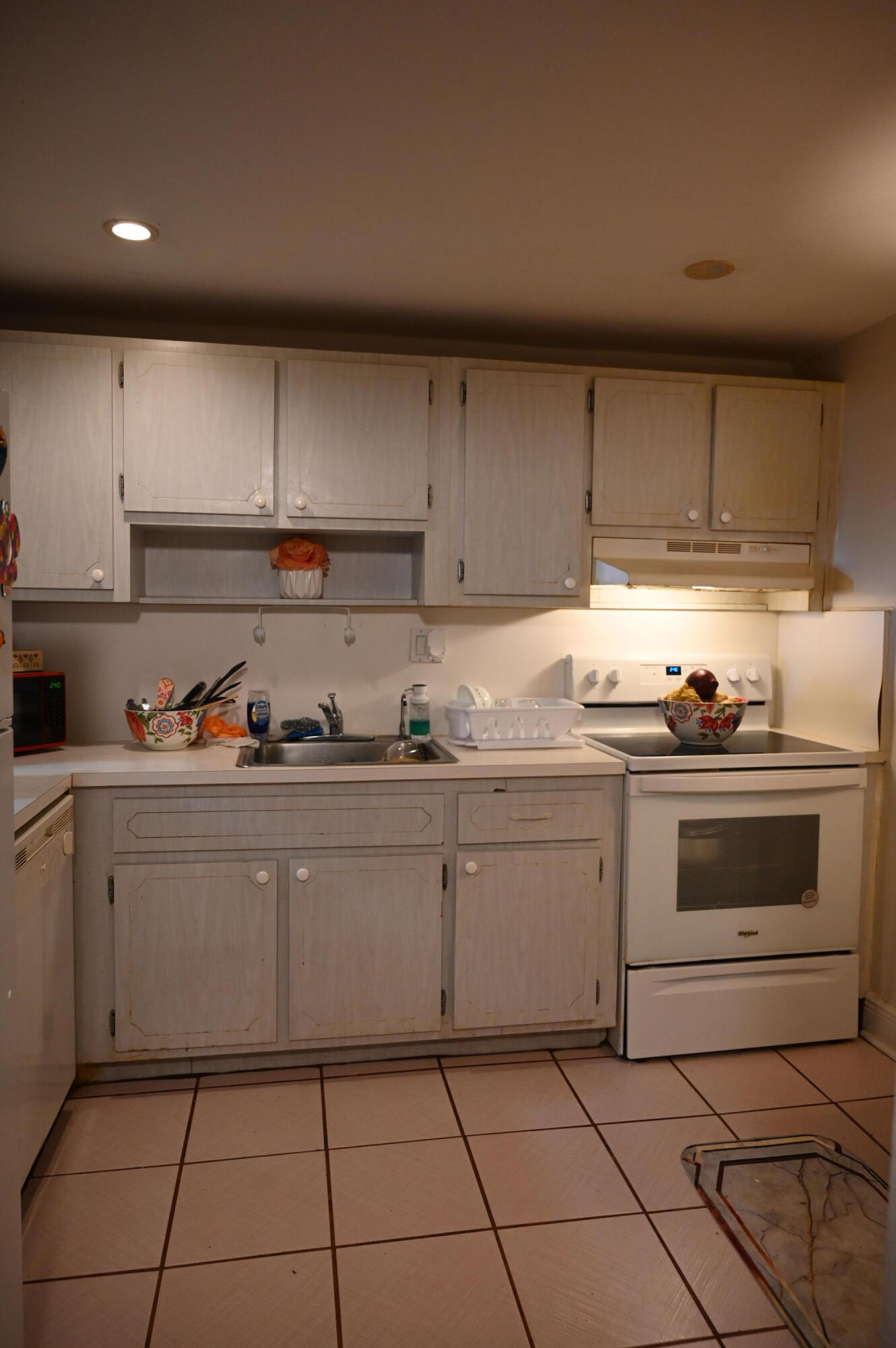 6215 West 20th Avenue, Unit 415 Hialeah, FL 33012 - Photo 19 of 39 a kitchen with granite countertop cabinets and white appliances