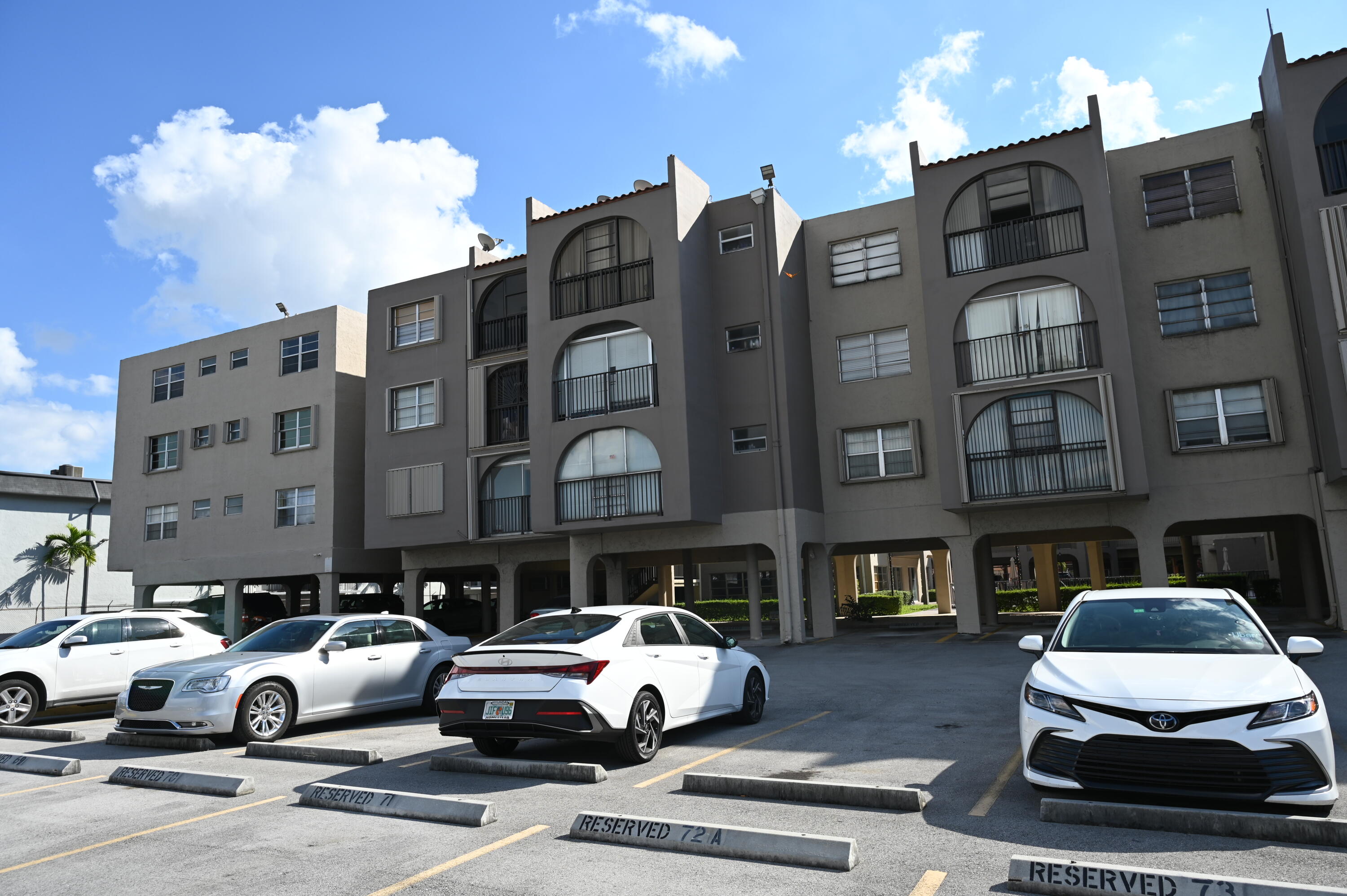 6215 West 20th Avenue, Unit 415 Hialeah, FL 33012 - Photo 2 of 39 a car parked in front of a building