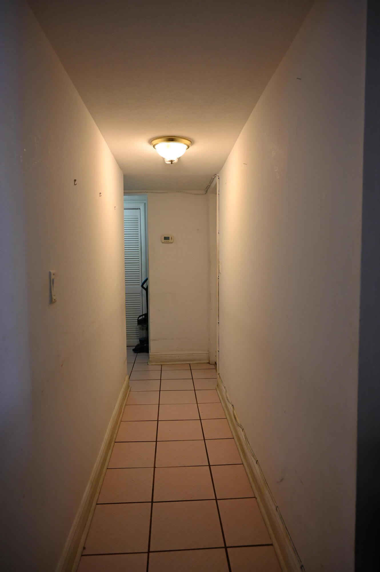 6215 West 20th Avenue, Unit 415 Hialeah, FL 33012 - Photo 21 of 39 a view of hallway with a window and a mirror