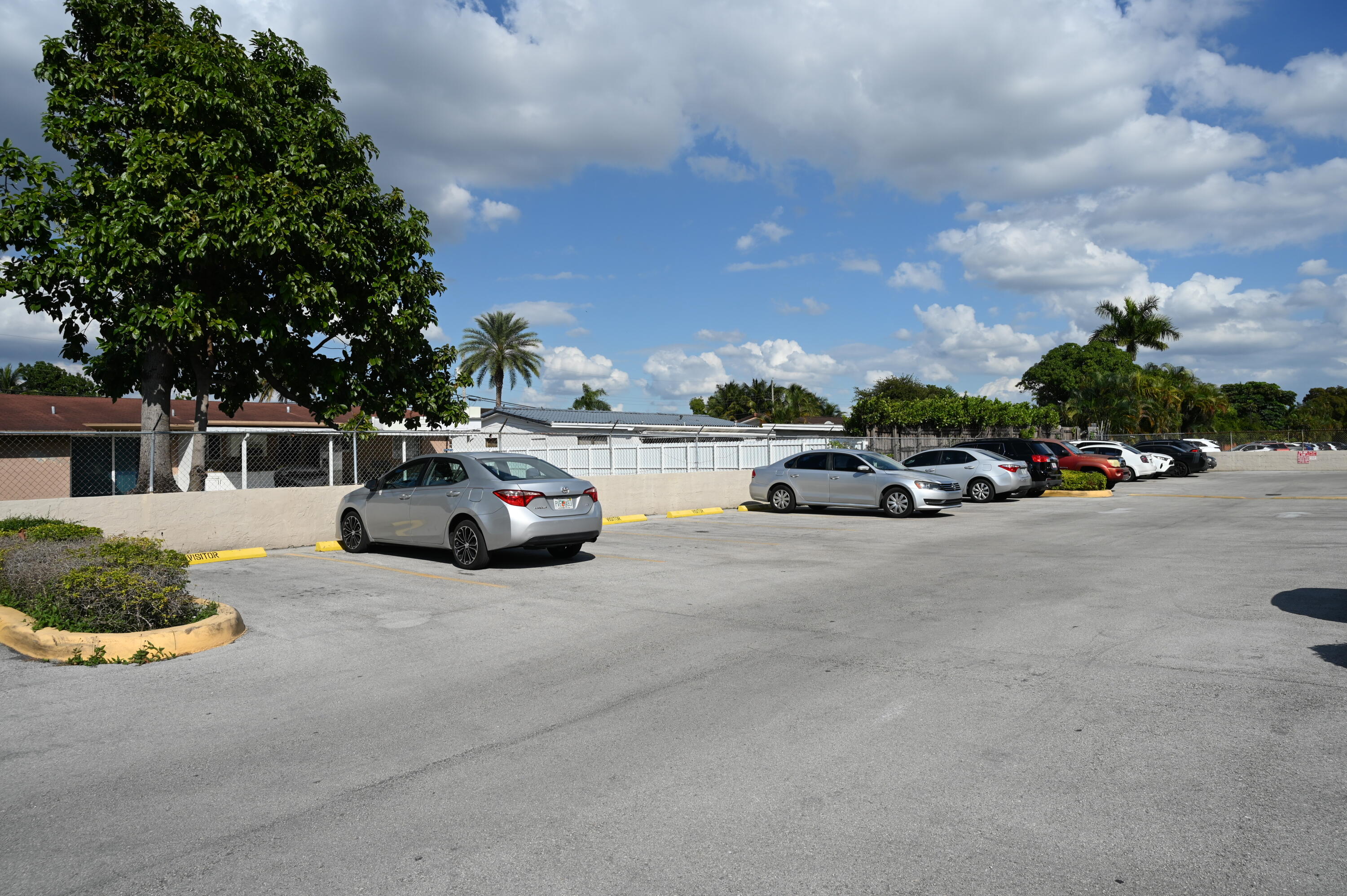 6215 West 20th Avenue, Unit 415 Hialeah, FL 33012 - Photo 4 of 39 a car parked on the side of a street