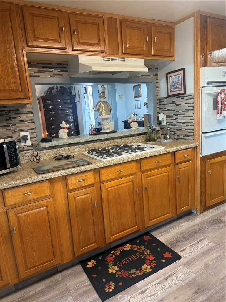 13393 Mariposa Road, Unit 97 Victorville, CA 92395 - Photo 13 of 32 a kitchen with stainless steel appliances granite countertop a sink stove and cabinets