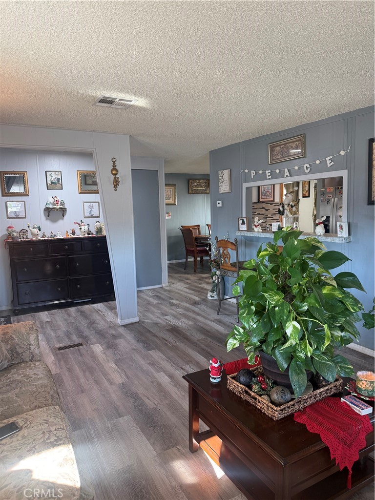 13393 Mariposa Road, Unit 97 Victorville, CA 92395 - Photo 4 of 32 a living room with furniture and a dining room