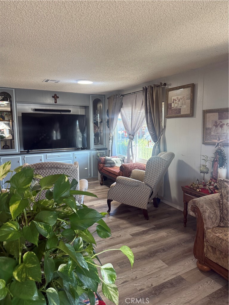 13393 Mariposa Road, Unit 97 Victorville, CA 92395 - Photo 6 of 32 a living room with furniture and a flat screen tv