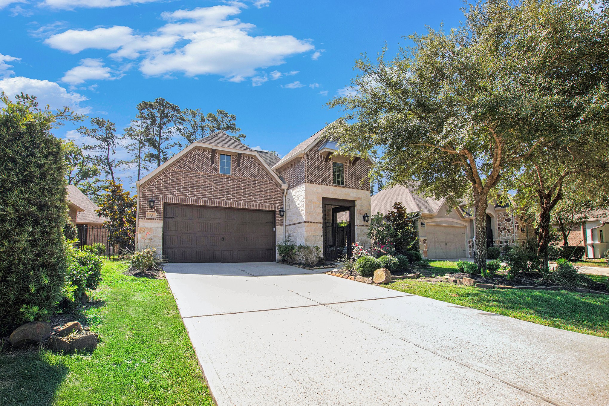 42 Sundown Ridge Place Tomball, TX 77375 - Photo 2 of 48 a front view of a house with a yard and garage