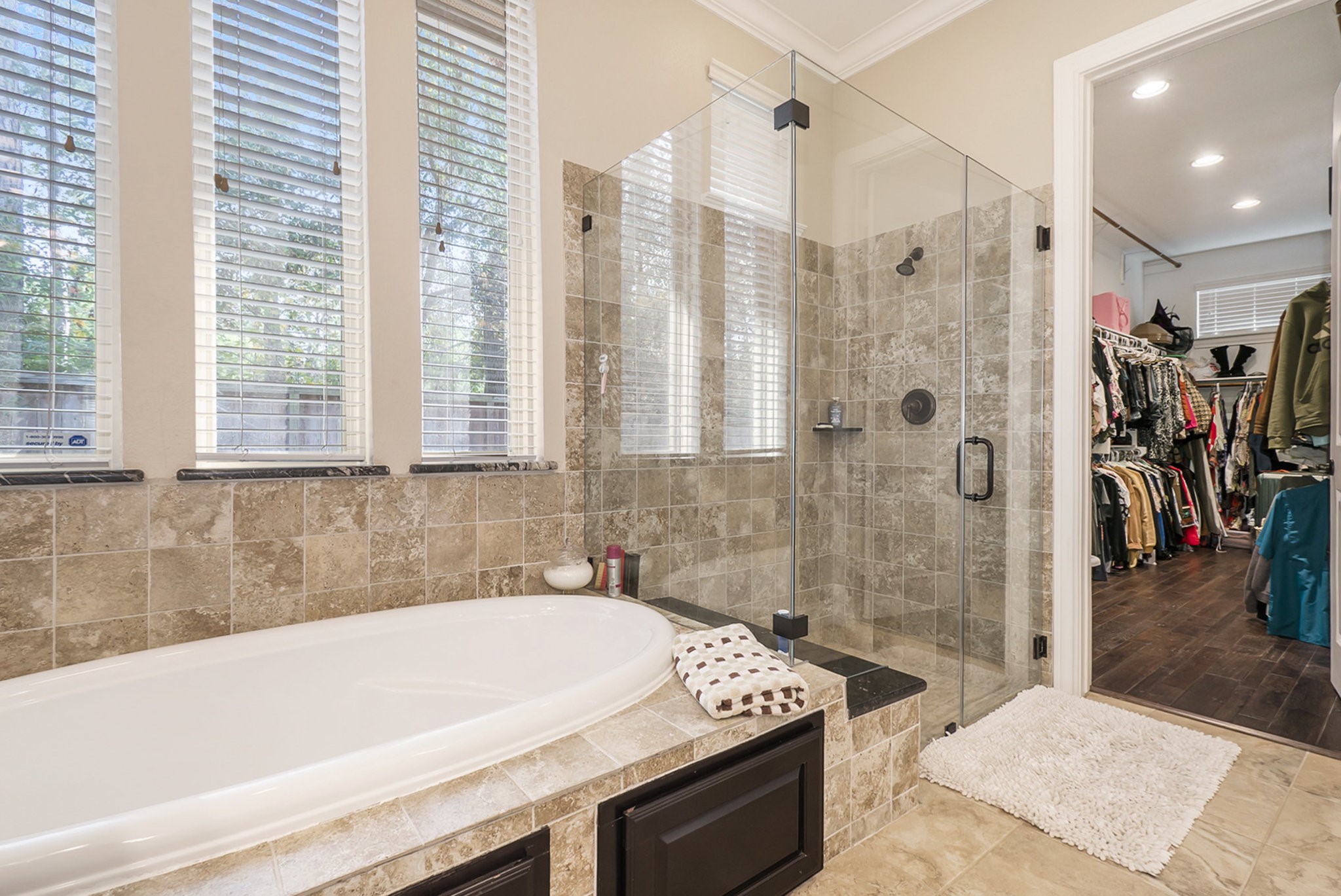 42 Sundown Ridge Place Tomball, TX 77375 - Photo 26 of 48 a bathroom with a tub a sink and a shower