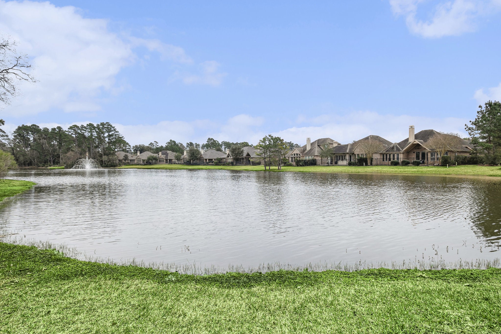 42 Sundown Ridge Place Tomball, TX 77375 - Photo 45 of 48 a view of a lake with houses in the back