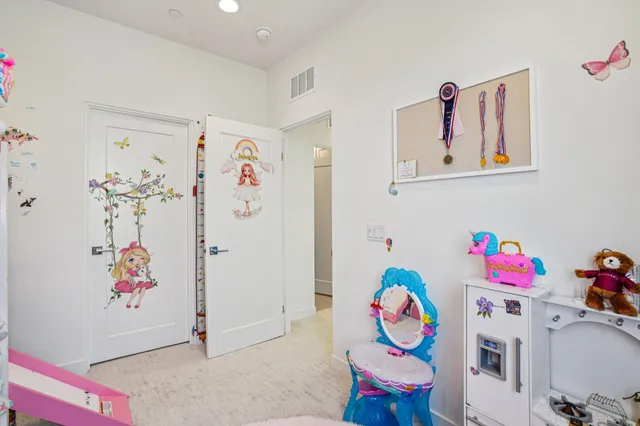 a living room with lots of furniture and kitchen view