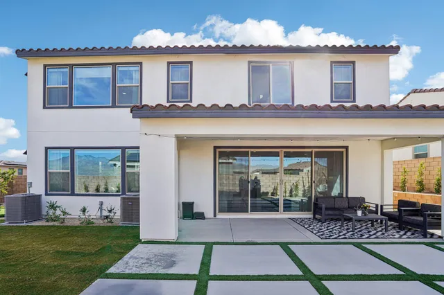 a view of a swimming pool with a patio and fire pit