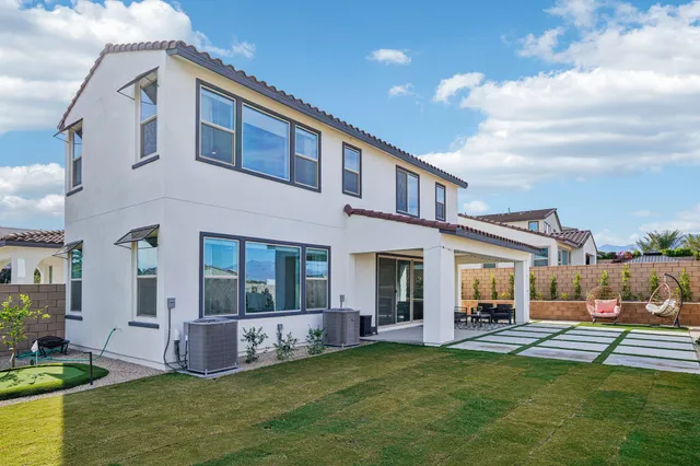 a living room with furniture a table and a potted plant