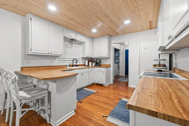 a kitchen with stainless steel appliances granite countertop a sink refrigerator and cabinets