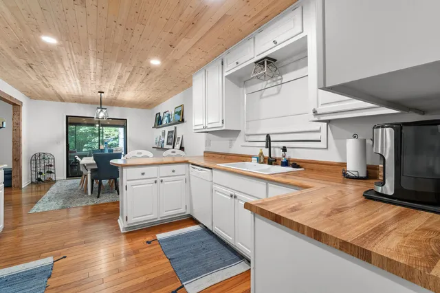 a kitchen with granite countertop a sink stove and cabinets