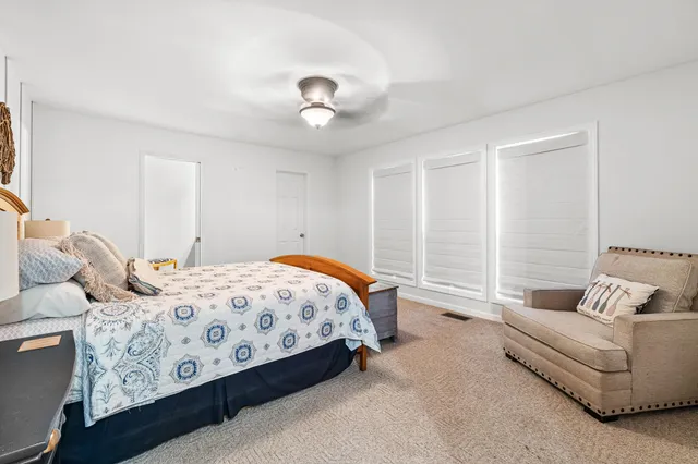 a bedroom with bed and a couch